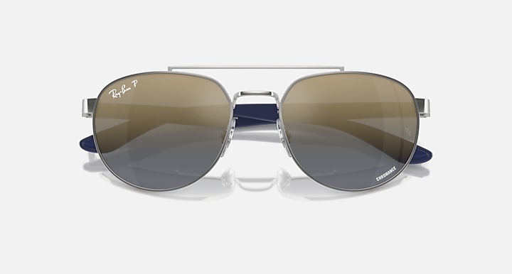 Ray-Ban sunglasses with silver frame, blue temples, brown gradient mirrored lenses