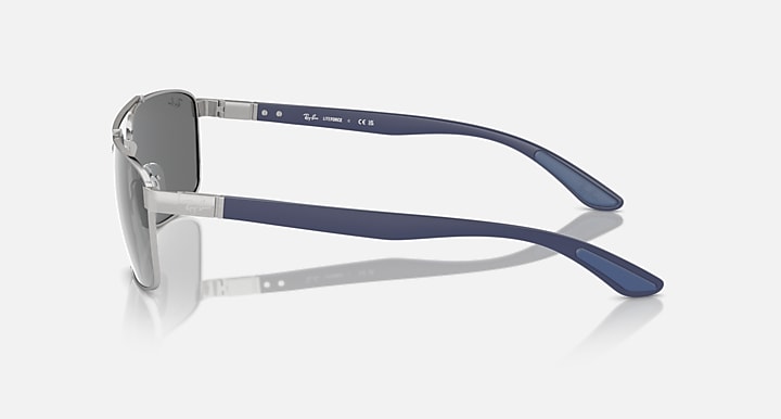 Sunglasses side view with grey mirrored lens and blue-accented metal temples