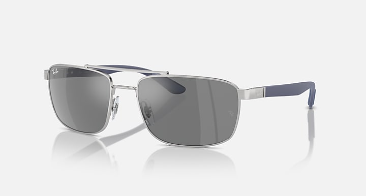 Sunglasses with grey mirrored lenses and silver frame with blue temple tips