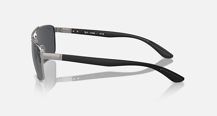 Rectangular metal sunglasses with dark tinted lenses and adjustable-looking hinge, side view
