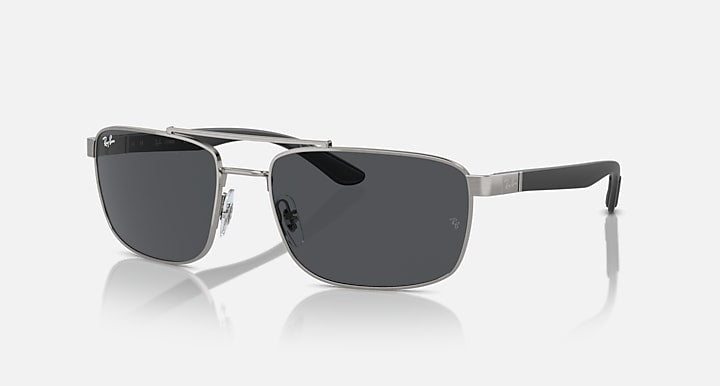 Rectangular metal sunglasses with dark tinted lenses and black-tinted temple tips, side view