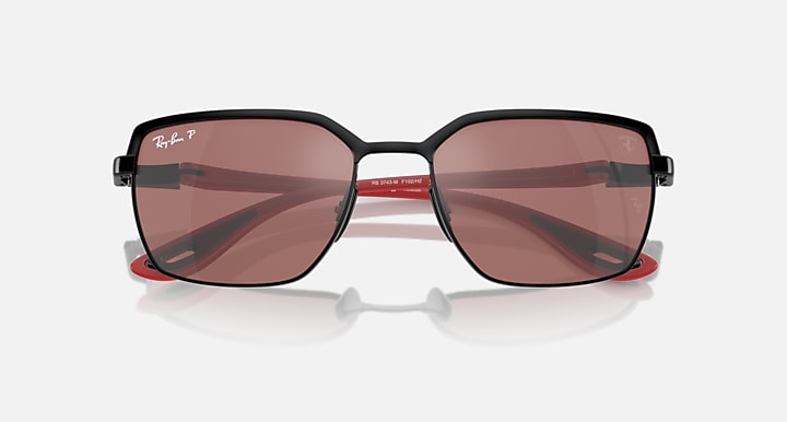Close front view of square sunglasses with dark frames and rose mirrored lenses