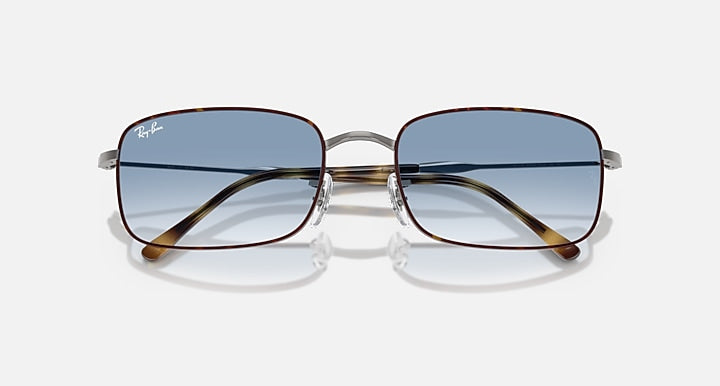 Sunglasses with blue lenses, silver frame, tortoise brown diagonal temple details