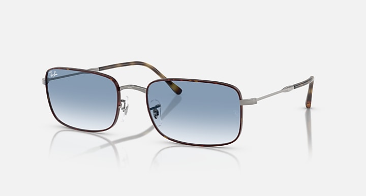 Square sunglasses with dark blue lenses, silver frame and tortoise brown temples