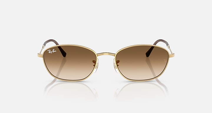 Gold oval sunglasses with warm brown lenses and slim metal temples