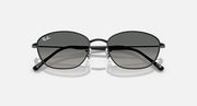 Sunglasses with dark lenses and black metal frames, thin oval shape.