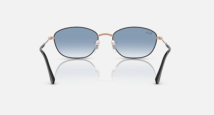 Sunglasses with blue tinted lenses and rose-gold/black metal frames, front view.