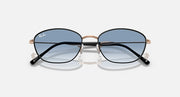 Sunglasses with blue tinted lenses and rose-gold/black metal frames, front view.