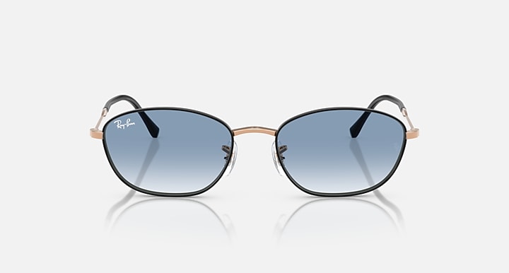 Sunglasses with blue tinted lenses and rose-gold/black metal frames, front view.