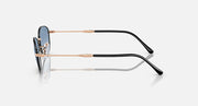Sunglasses with blue tinted lenses and rose-gold/black metal frames, side view.