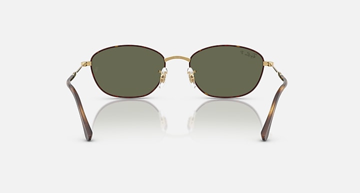 Ray-Ban oval sunglasses with dark green lenses, gold frame, tortoise arms