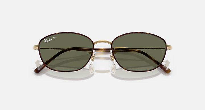 Ray-Ban sunglasses with dark green lenses and tortoise temple accents