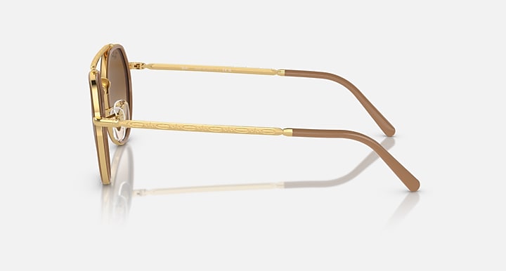Ray-Ban round sunglasses side view, gold metal frame with brown lenses