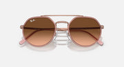 Round sunglasses front view with brown lenses and copper metal bridge detail