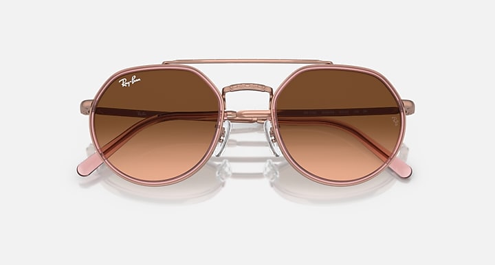 Round sunglasses front view with brown lenses and copper metal bridge detail