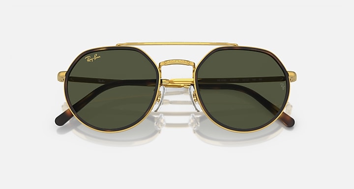 Round sunglasses front view with dark green lenses and gold metal bridge