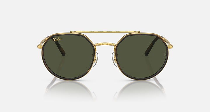 Round sunglasses front view with gold metal frame and dark green lenses