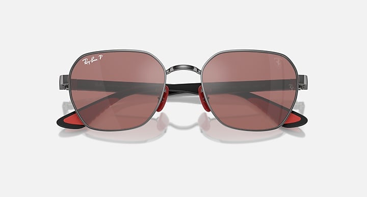 Sunglasses with dark frame and pink-brown gradient lenses, round-oval eye shape.