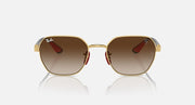 Sunglasses with gold frame and warm brown lenses, small red accent at hinges.