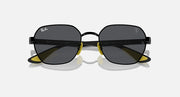 Black oval sunglasses with dark lenses, yellow hinge details and slim metal arms