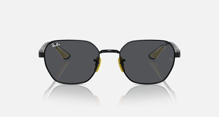 Black rounded sunglasses with dark grey tinted lenses, small yellow accents at hinges