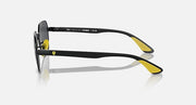 Black sunglasses side view with dark lenses and yellow-tipped temple ends