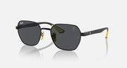 Black oval sunglasses with dark grey lenses, yellow temple accents and metal hinges