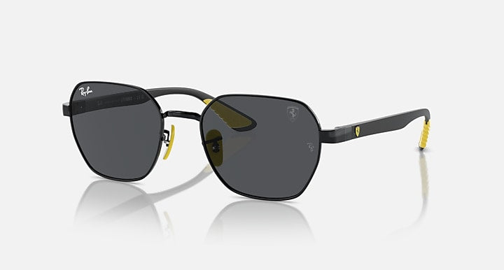 Black oval sunglasses with dark grey lenses, yellow temple accents and metal hinges
