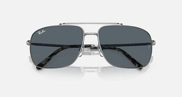 Square sunglasses with dark gray lenses, silver frame, angled front