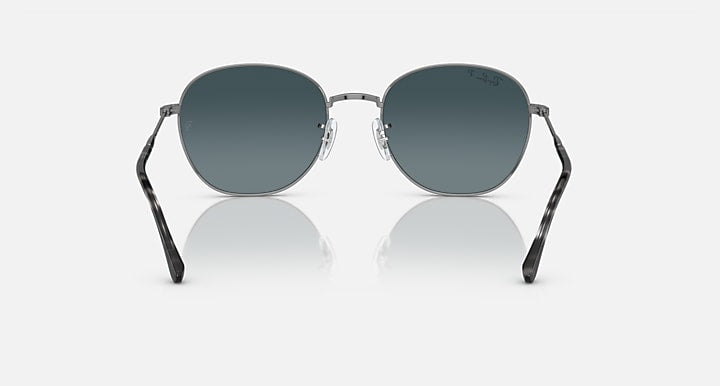 Round sunglasses with silver-tone frame, dark tinted lenses, and black temples.
