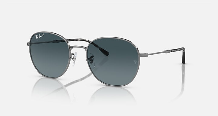 Round sunglasses with silver-tone metal frame and dark blue tinted lenses.