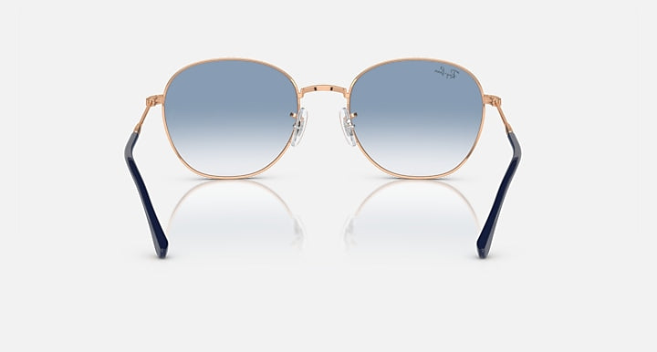 Round sunglasses with rose-gold frame, dark tinted lenses, and navy temples.