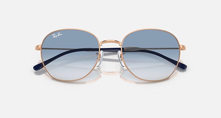 Round sunglasses with rose-gold frame and dark top-gradient blue tinted lenses.