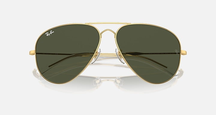 Aviator sunglasses with gold frame and olive green mirrored lenses, close front angle