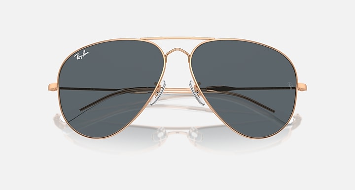Aviator sunglasses with gold frame and dark gray mirrored lenses, close front angle