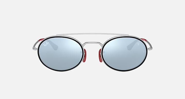 Ray-Ban RB3847M round sunglasses front view with blue tinted lenses and red accents