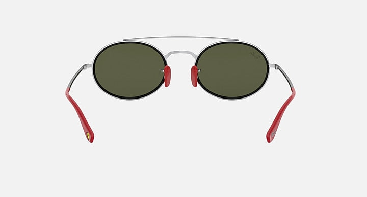 Ray-Ban RB3847M sunglasses front view with dark green tinted lenses and red metal arms