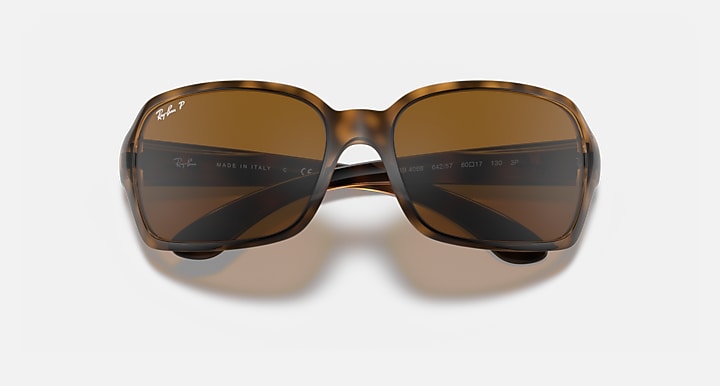 Front view of square sunglasses with dark brown gradient lenses and light frame