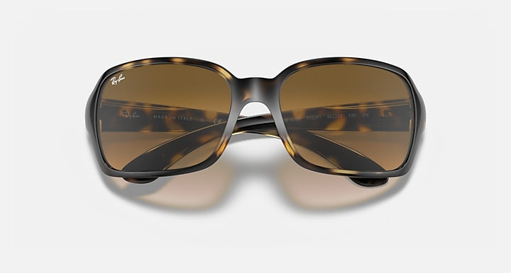 Front view of square sunglasses with dark brown tinted lenses and light Havana clear frame