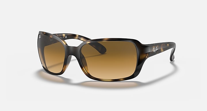 Angled view of square sunglasses with brown gradient lenses and Havana clear frame