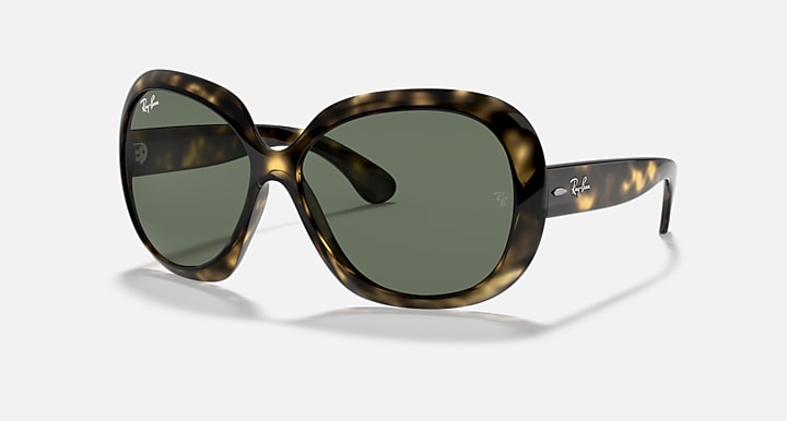 Wrap sunglasses with tortoiseshell frame and dark green lenses