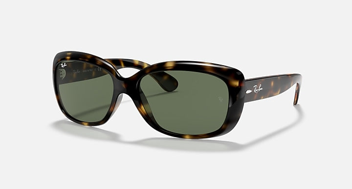 Tortoise-style sunglasses with dark green lenses and curved oval frames