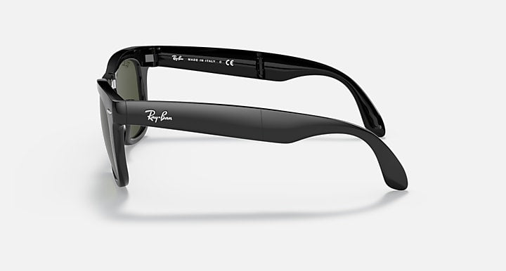 Folding Wayfarer sunglasses, matte black frame with dark green lenses, side view