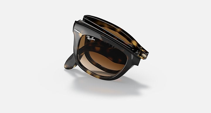 Ray-Ban Folding Wayfarer sunglasses shown folded with brown tinted lenses