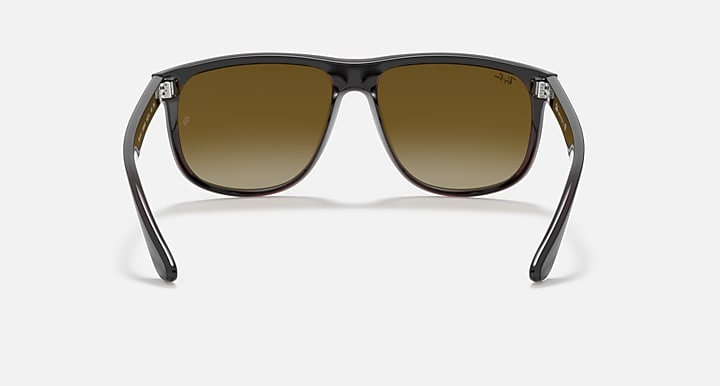 Sunglasses front view with dark frame and gradient amber lenses, metal hinges.