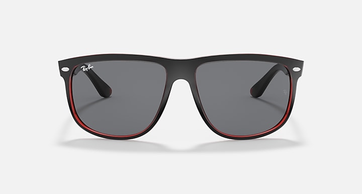 Sunglasses front view with black frame, gray lenses, and red trim accents.