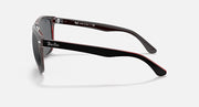 Sunglasses side view with black arms, gray lenses, and red edge trim.