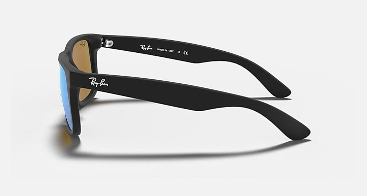 Black rectangular sunglasses side view with blue-tinted lenses and logo arms