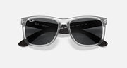Ray-Ban Justin sunglasses with clear frame and dark gradient lenses, front view.