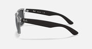 Ray-Ban Justin sunglasses, side profile with clear frame and dark gray lenses.